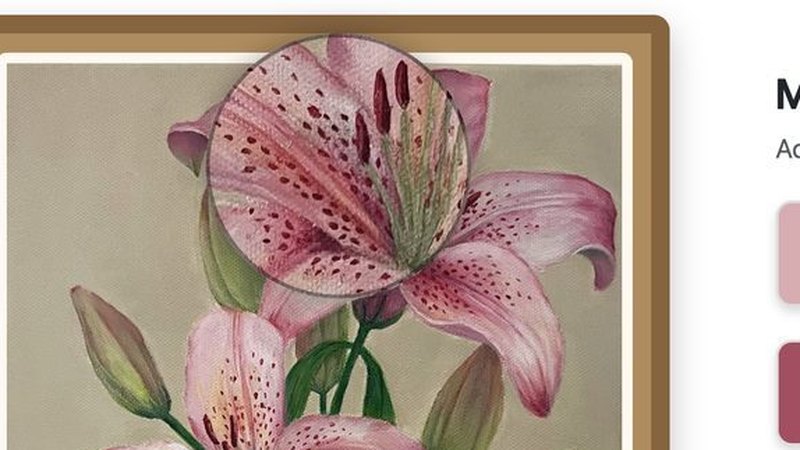 Close-up of the magnifier lens over the lily painting, showing the brushwork.